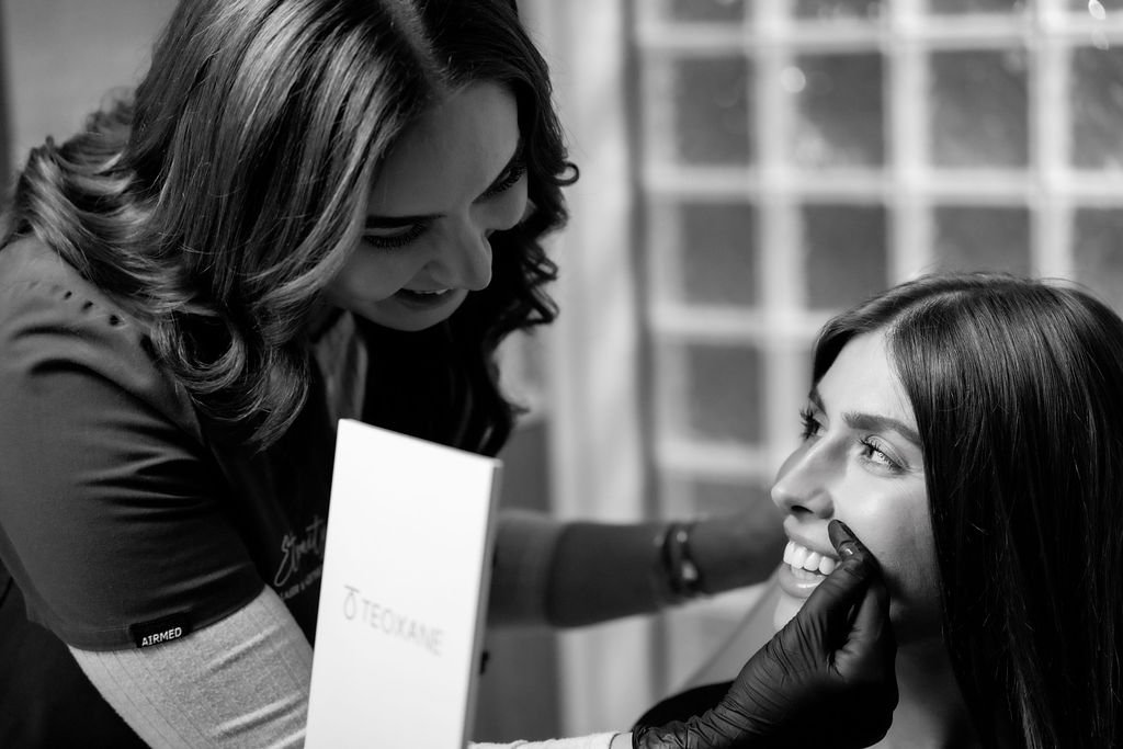 Monica assessing client skin for melasma treatment at Eternity Laser & Aesthetics Dural